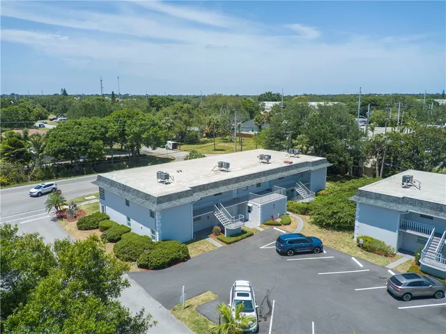 an aerial view of a house with outdoor space patio and trees all around