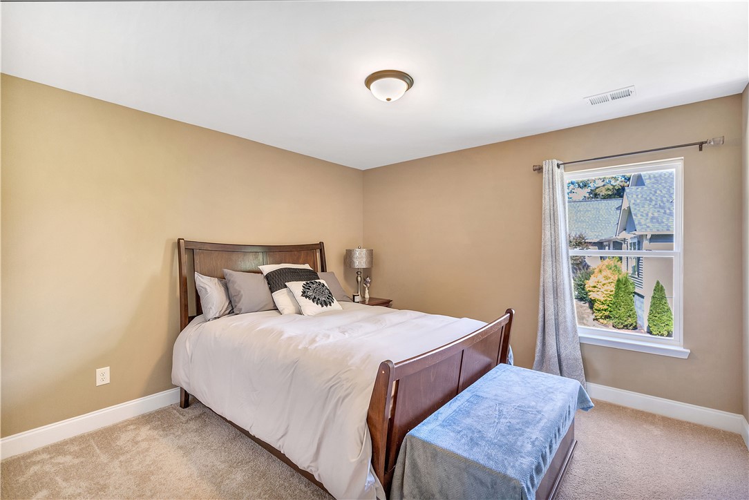 3004 Cobbs Way Anderson, SC 29621 - Photo 27 of 46 Plush carpeting and a wide window frame peaceful neighborhood views in this comfortable bedroom.