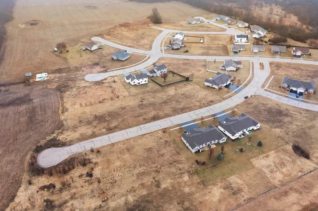 an aerial view of a house with a yard