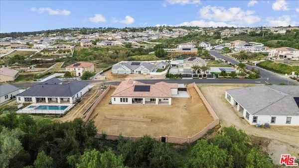 an aerial view of residential houses with outdoor space and river