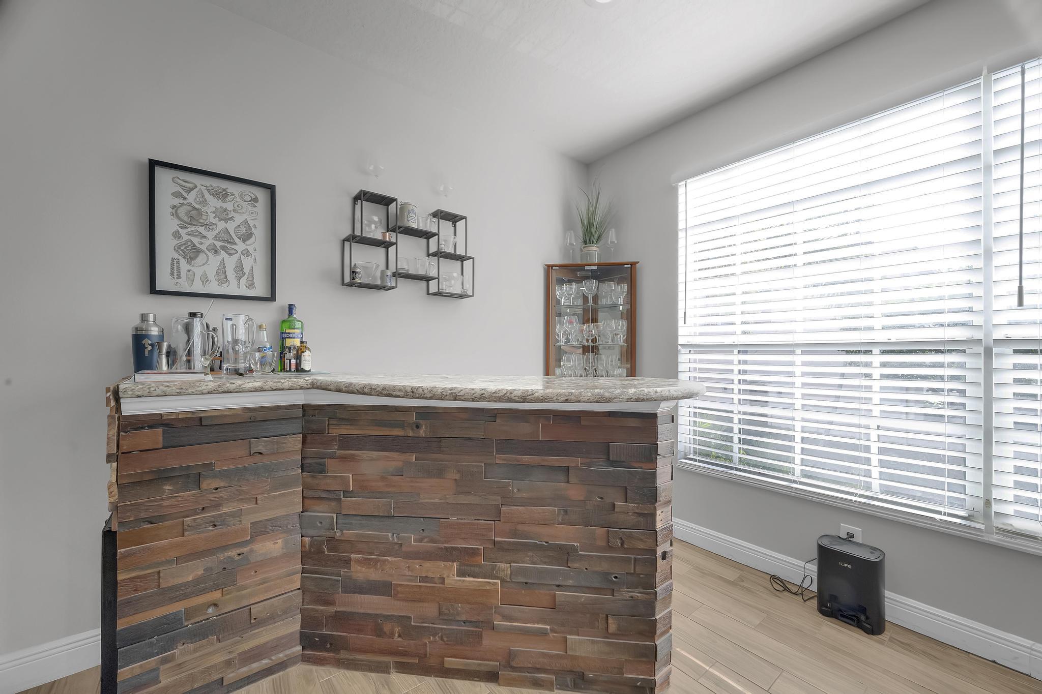 5600 Northeast Trieste Terrace Boca Raton, FL 33487 - Photo 15 of 44 a room with a furniture and a window