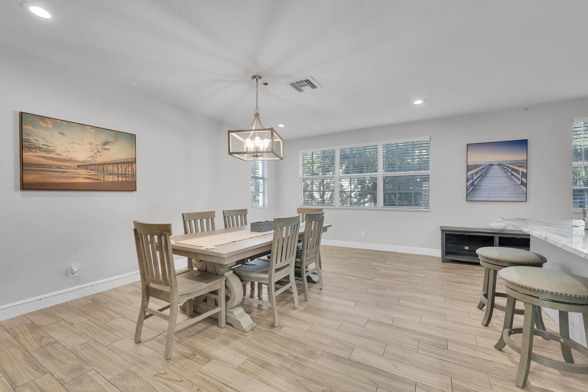 5600 Northeast Trieste Terrace Boca Raton, FL 33487 - Photo 17 of 44 a view of a dining room with furniture window and wooden floor