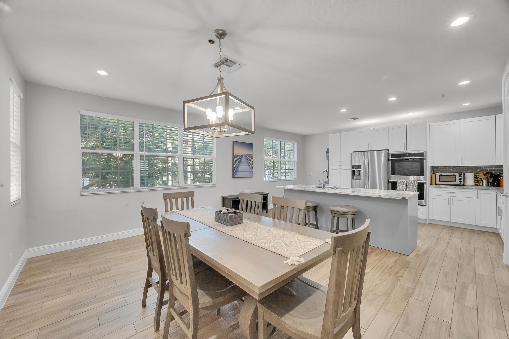 5600 Northeast Trieste Terrace Boca Raton, FL 33487 - Photo 18 of 44 a view of a dining room with furniture window and wooden floor