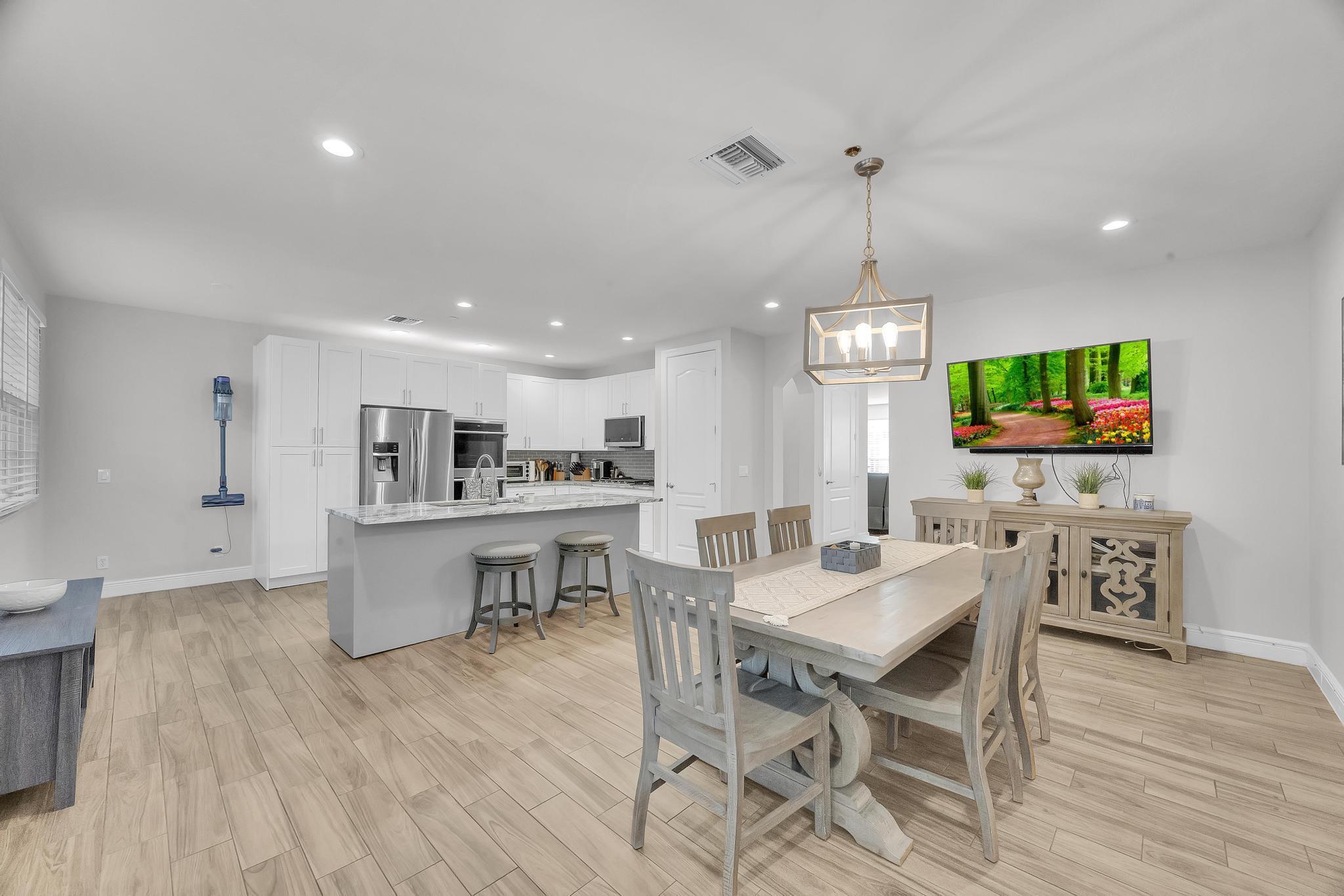 5600 Northeast Trieste Terrace Boca Raton, FL 33487 - Photo 19 of 44 a view of a dining room with furniture window and wooden floor