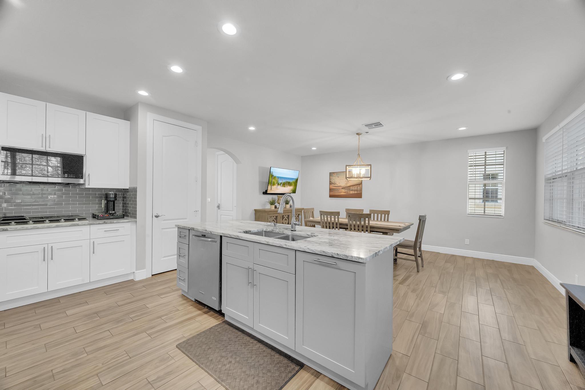 5600 Northeast Trieste Terrace Boca Raton, FL 33487 - Photo 21 of 44 a kitchen with sink stove and cabinets