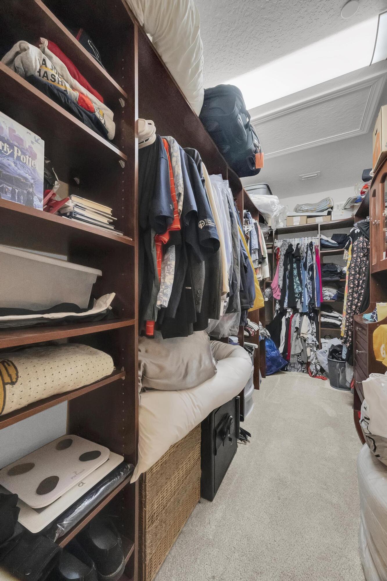 5600 Northeast Trieste Terrace Boca Raton, FL 33487 - Photo 27 of 44 a view of walk in closet with clothes and shoes