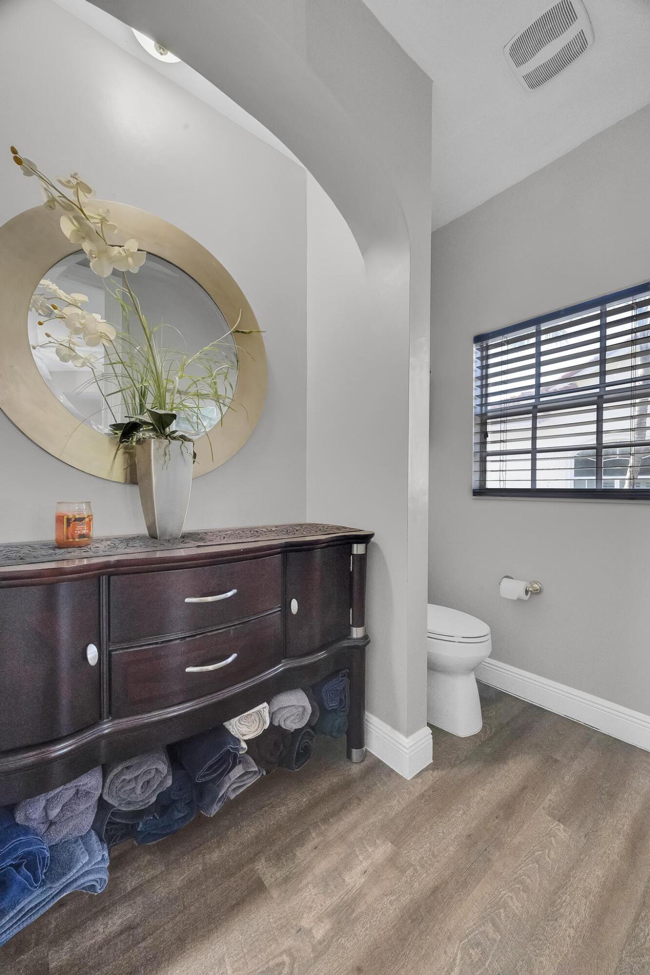 5600 Northeast Trieste Terrace Boca Raton, FL 33487 - Photo 28 of 44 a living room with a mirror