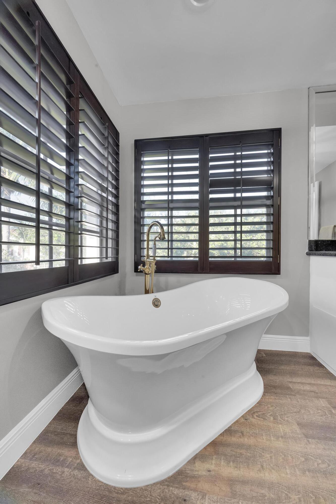 5600 Northeast Trieste Terrace Boca Raton, FL 33487 - Photo 30 of 44 a bathroom with a bathtub