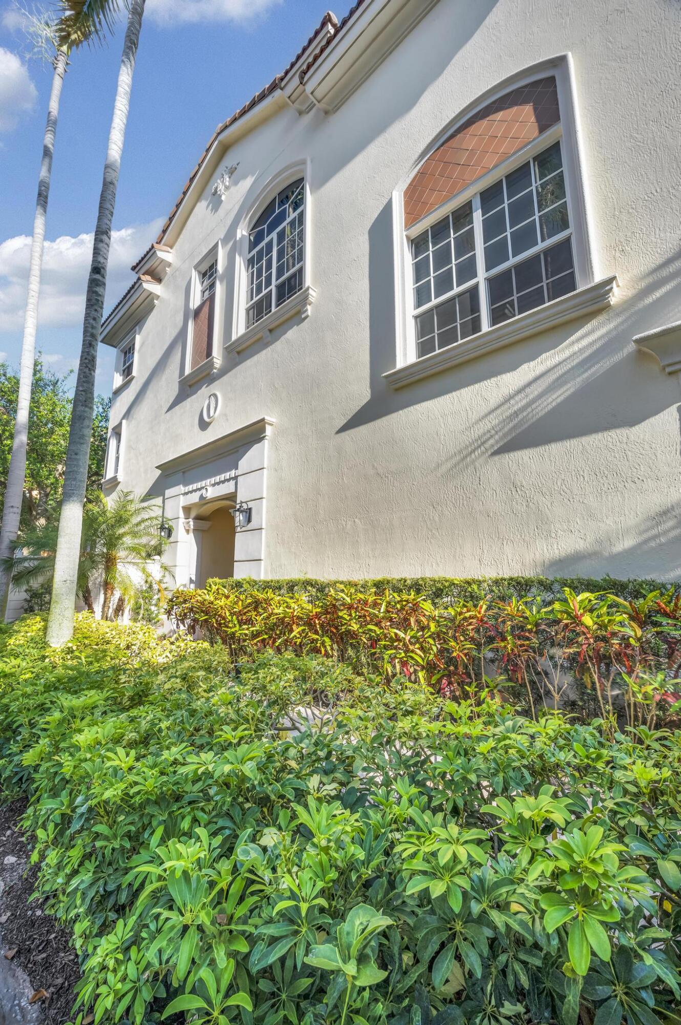 5600 Northeast Trieste Terrace Boca Raton, FL 33487 - Photo 3 of 44 a front view of a house with a yard