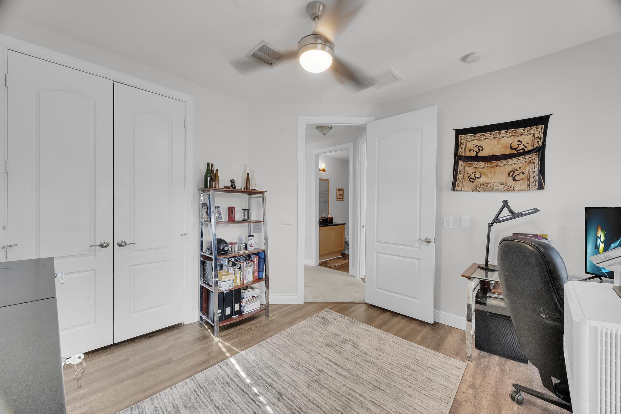 5600 Northeast Trieste Terrace Boca Raton, FL 33487 - Photo 34 of 44 a view of a workspace with furniture and wooden floor