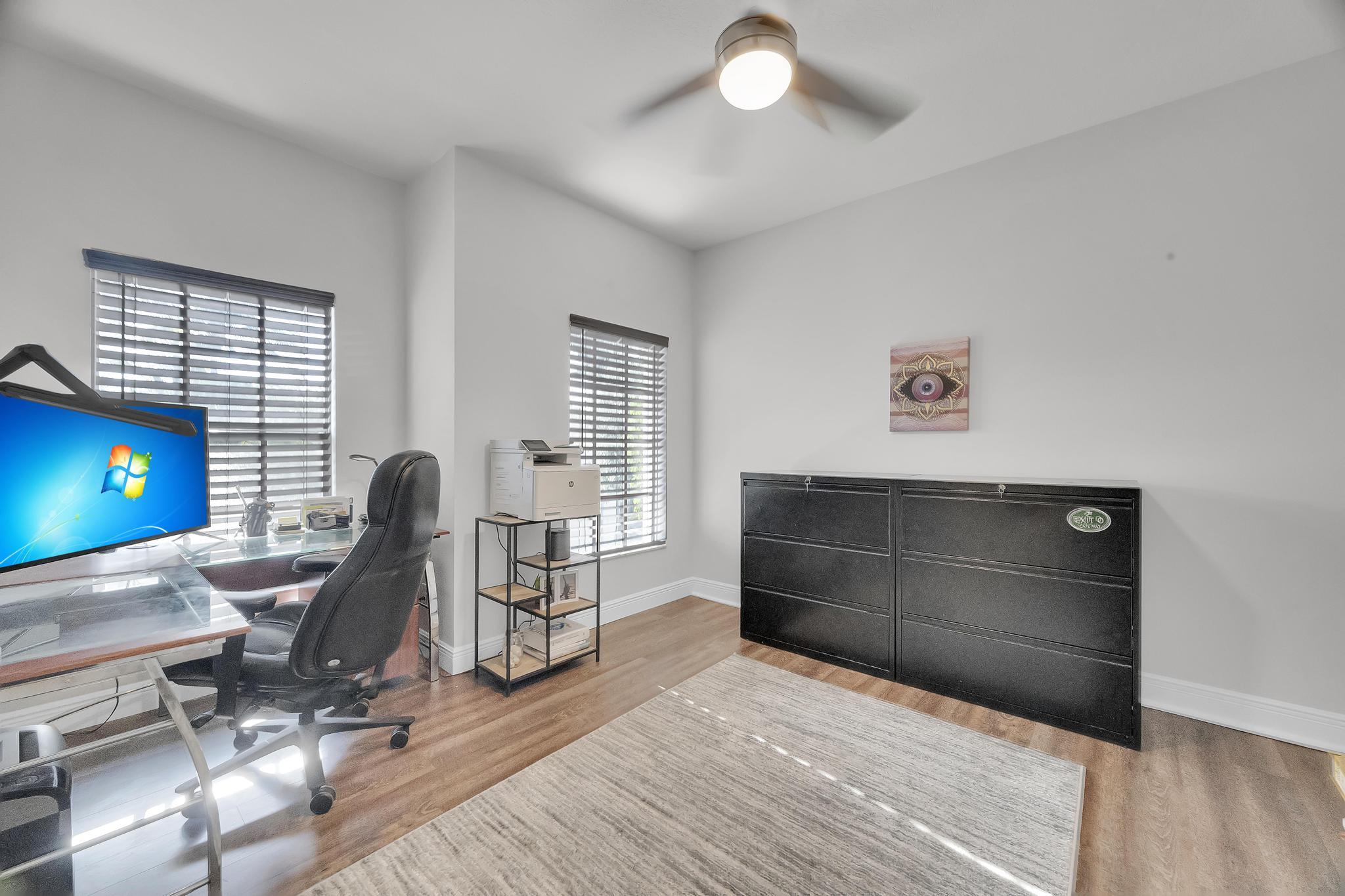 5600 Northeast Trieste Terrace Boca Raton, FL 33487 - Photo 35 of 44 a view of a workspace with furniture and a window