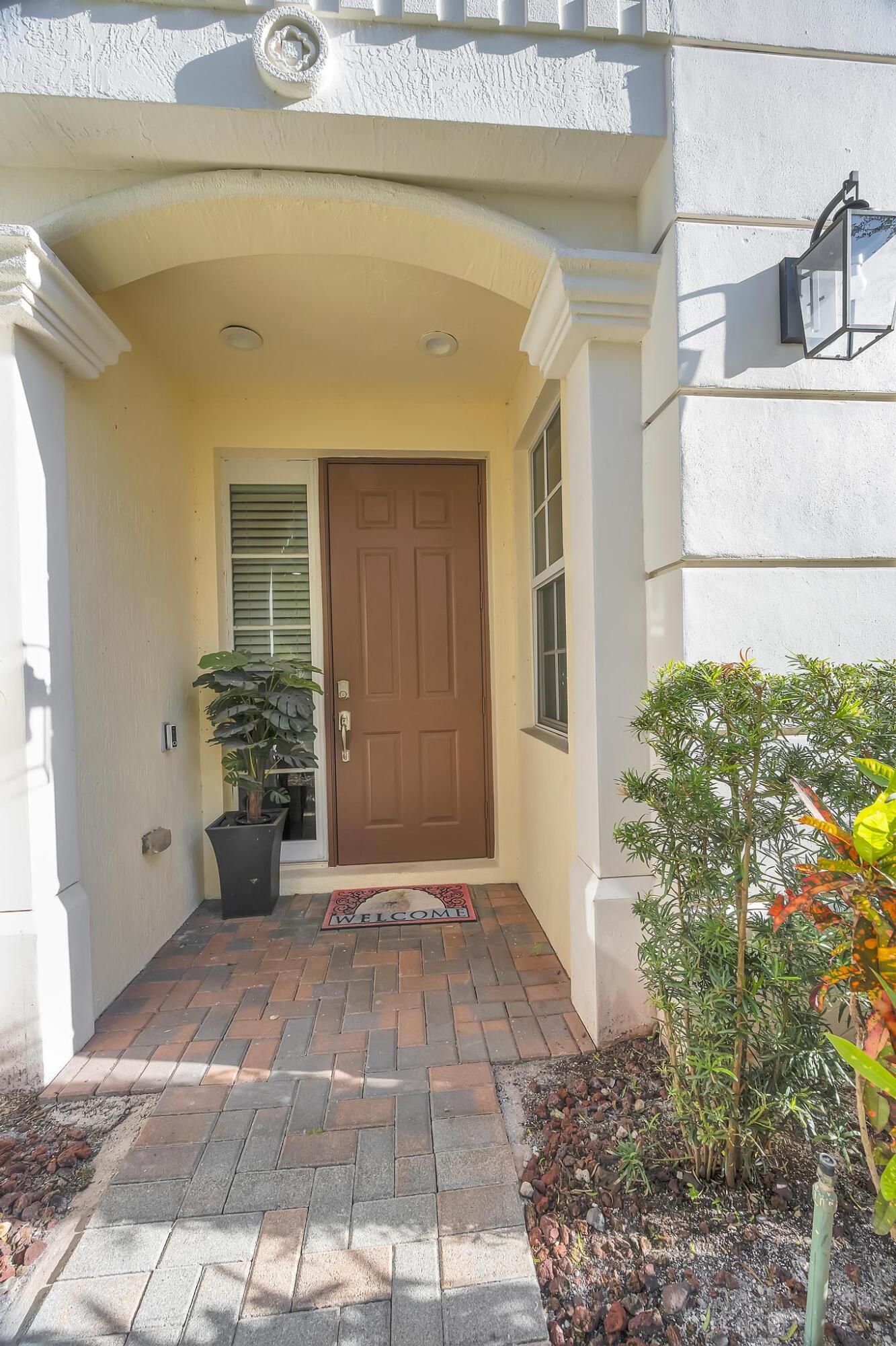 5600 Northeast Trieste Terrace Boca Raton, FL 33487 - Photo 4 of 44 a view of a entryway door of the house