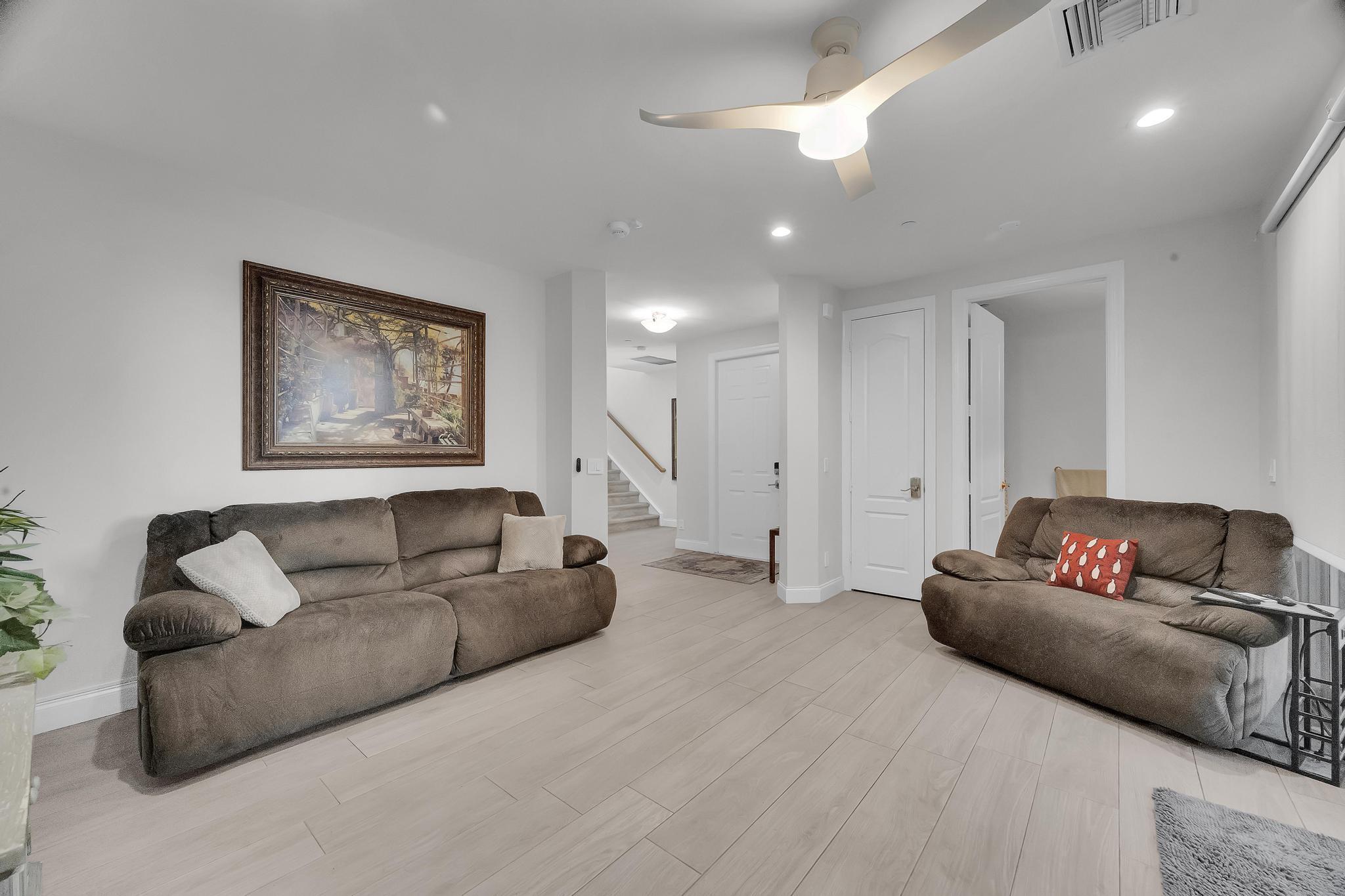5600 Northeast Trieste Terrace Boca Raton, FL 33487 - Photo 5 of 44 a living room with furniture and a couch