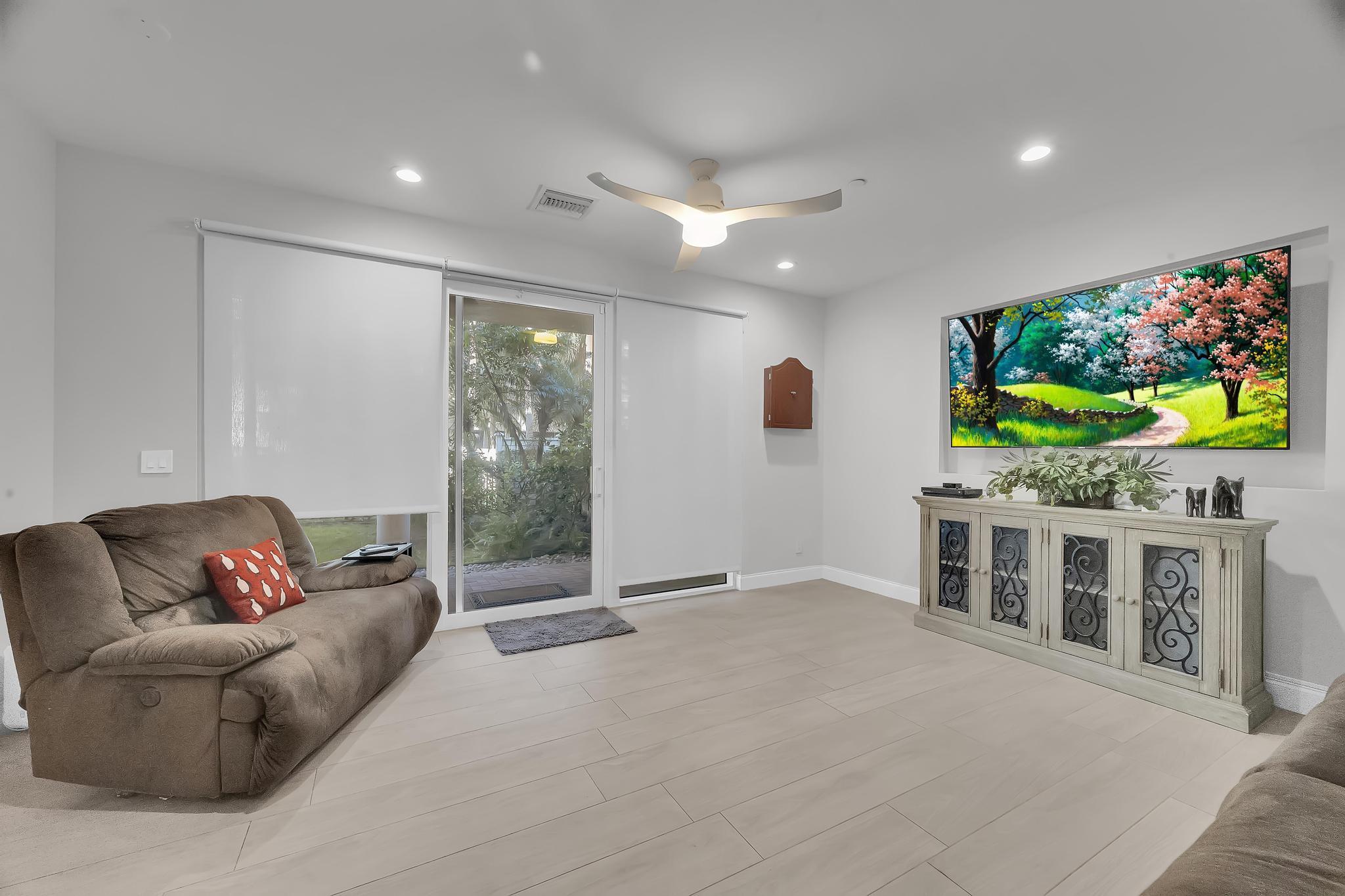5600 Northeast Trieste Terrace Boca Raton, FL 33487 - Photo 6 of 44 a living room with furniture and a flat screen tv