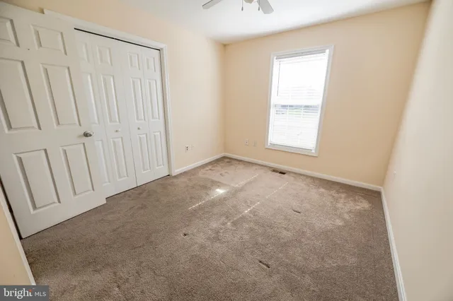 a view of a big room with a chandelier fan