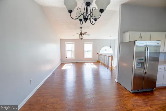 a kitchen with stainless steel appliances granite countertop a refrigerator a stove top oven a sink and dishwasher