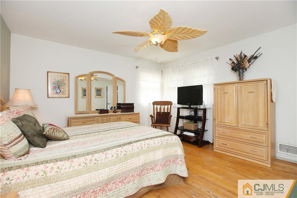 33 Glen Gary Road Middlesex, NJ 08846 - Photo 13 of 25 a bedroom with a bed and a chandelier