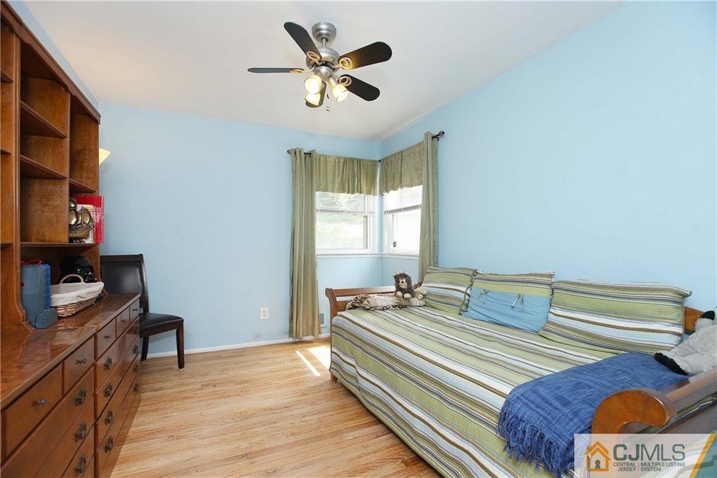 33 Glen Gary Road Middlesex, NJ 08846 - Photo 15 of 25 a bedroom with a bed and a chandelier