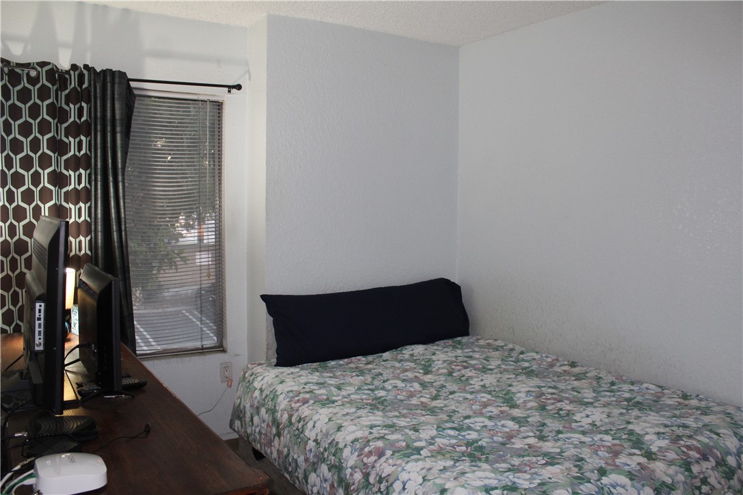 12141 Centralia Street, Unit 119 Lakewood, CA 90715 - Photo 15 of 31 a bedroom with a bed and a mirror