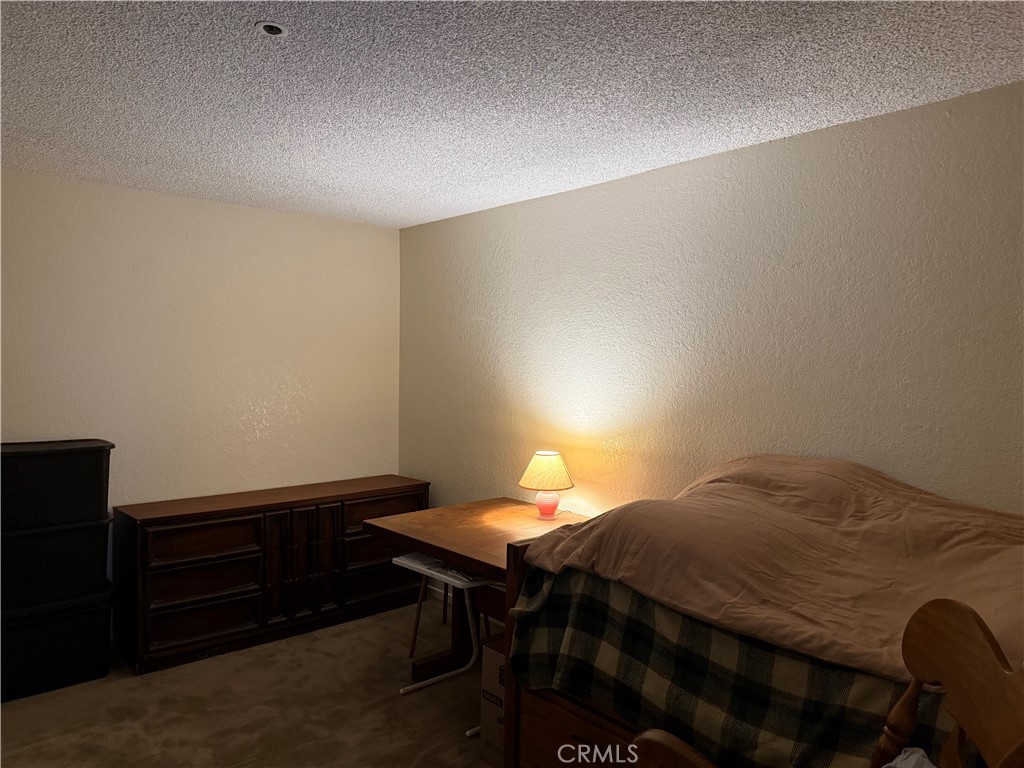12141 Centralia Street, Unit 119 Lakewood, CA 90715 - Photo 16 of 31 a bedroom with a bed and a table in it