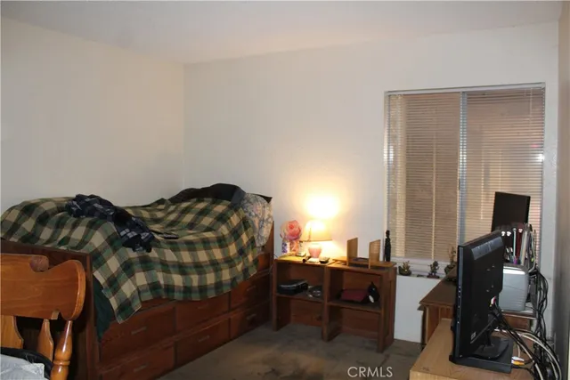 a bedroom with a bed and a desk