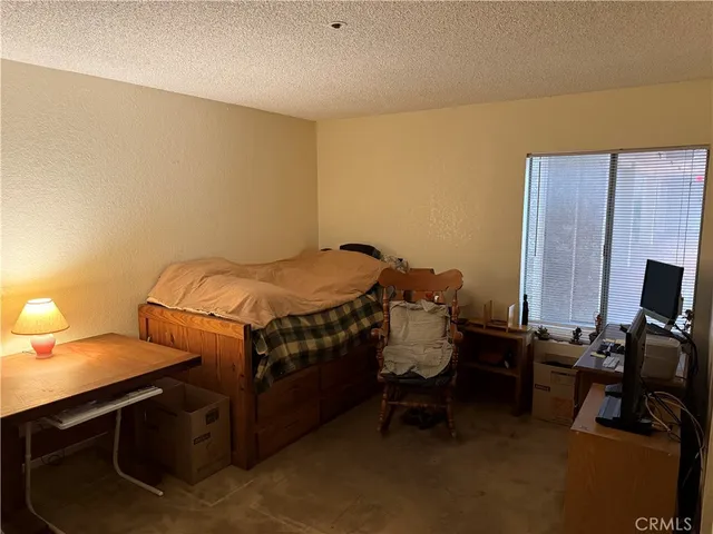 a bedroom with a bed and a table in it