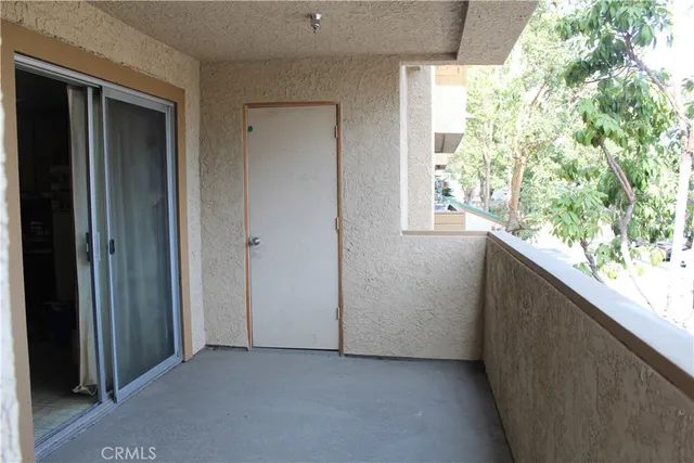 a view of a room that has a window and a door
