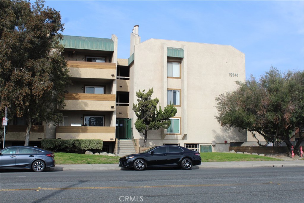 12141 Centralia Street, Unit 119 Lakewood, CA 90715 - Photo 2 of 31 a front view of a building with street