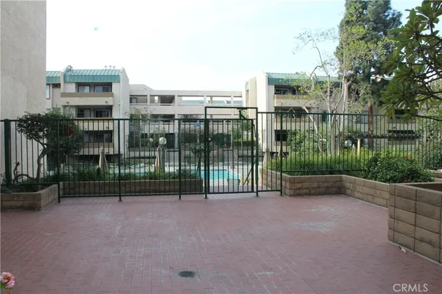 a view of a patio with chairs and potted plants