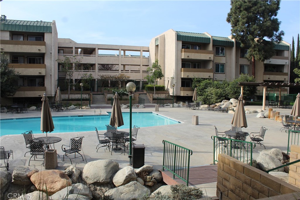 12141 Centralia Street, Unit 119 Lakewood, CA 90715 - Photo 24 of 31 a view of the patio with couches and a table and chairs
