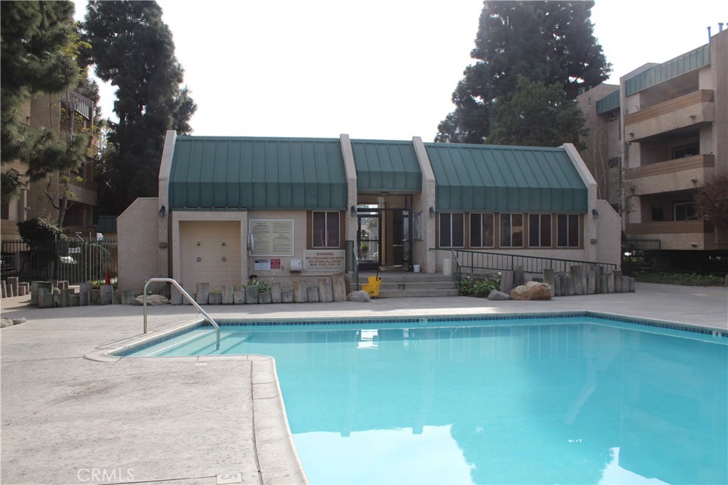 12141 Centralia Street, Unit 119 Lakewood, CA 90715 - Photo 26 of 31 a house view with swimming pool and sitting space