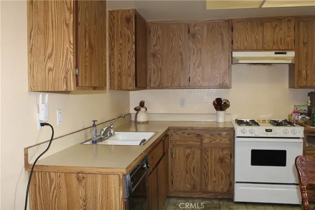 a kitchen with a sink cabinets and appliances