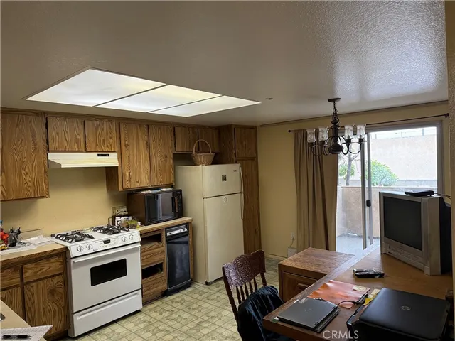 a kitchen with stainless steel appliances a stove a refrigerator and a microwave