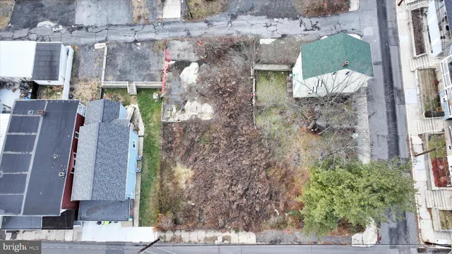 a aerial view of a house with a yard and large tree