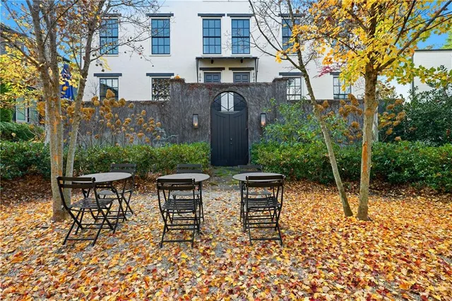 a view of a chairs and table in backyard