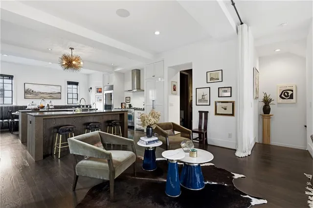 a living room with furniture or wooden floor and a large window