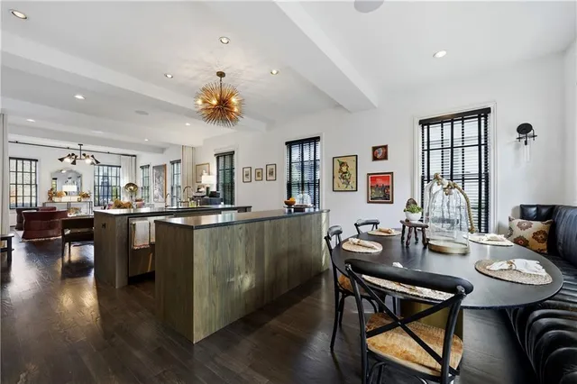 a kitchen with kitchen island a counter top space a sink stainless steel appliances and cabinets