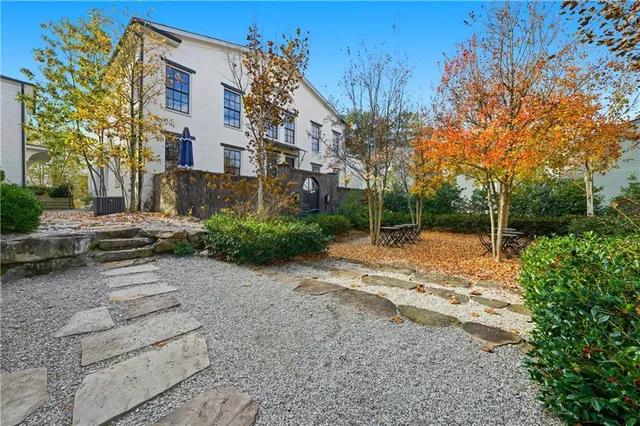 a view of a street with a house in the background