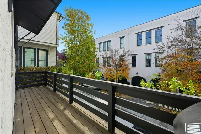 a spacious bedroom with a bed a table and large windows