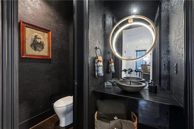 a bedroom with a bed television on desk and a window