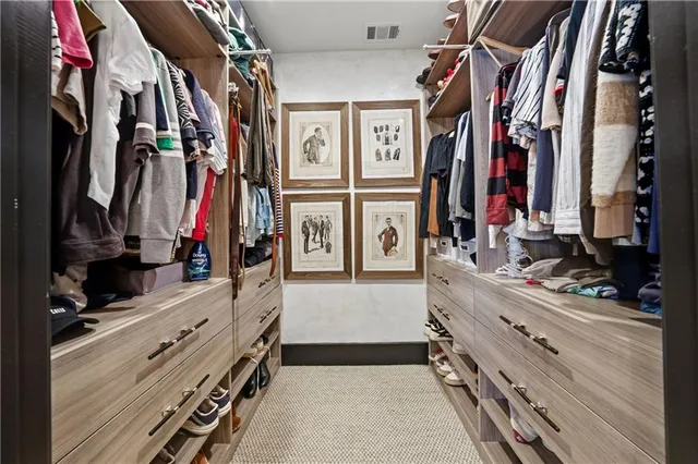 a bedroom with a bed dresser and a window