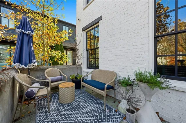 a living room with furniture a fireplace and a chandelier