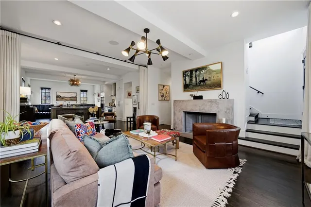 a living room with furniture a wooden floor and chandelier