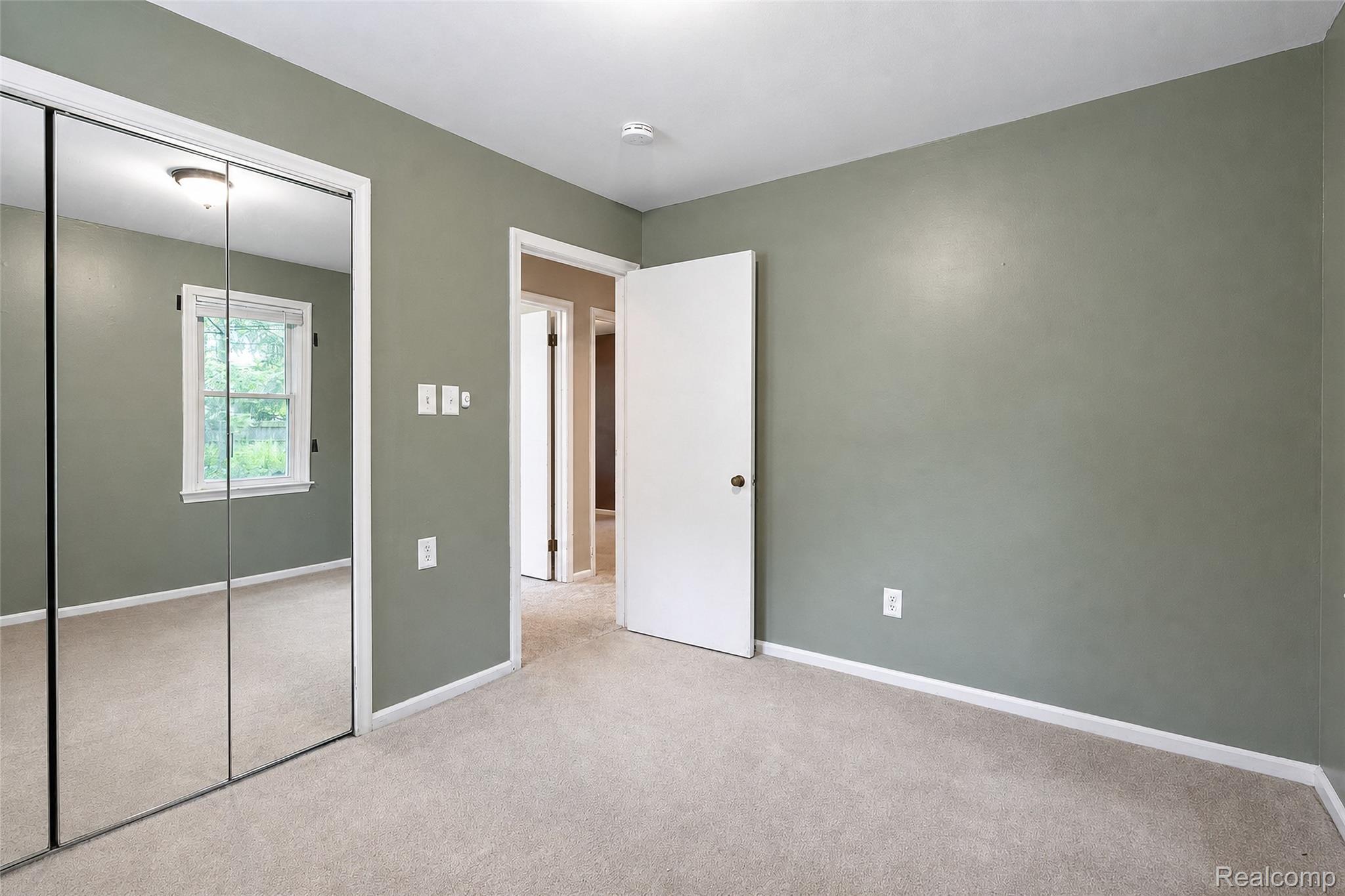 1846 Pembroke Road Birmingham, MI 48009 - Photo 36 of 37 Mirrored closet doors, light-toned wall-to-wall carpeting, and a white-trimmed window