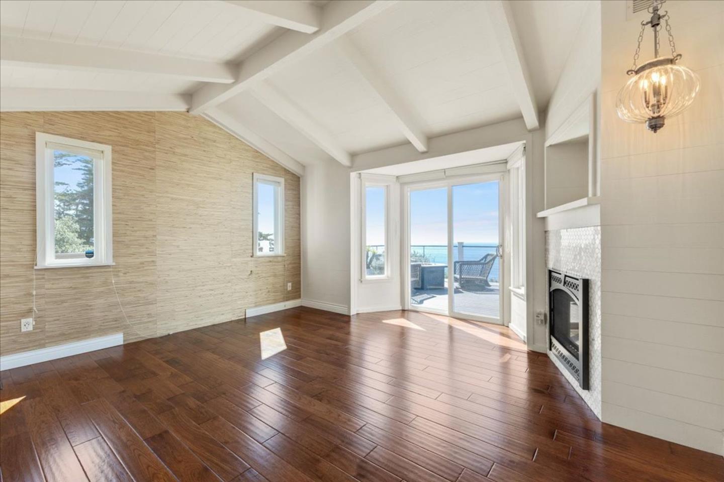 15 Mentone Road Carmel, CA 93923 - Photo 25 of 47 an empty room with wooden floor and windows