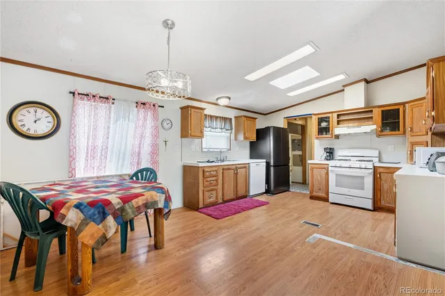 a kitchen that has a lot of cabinets a sink and a stove