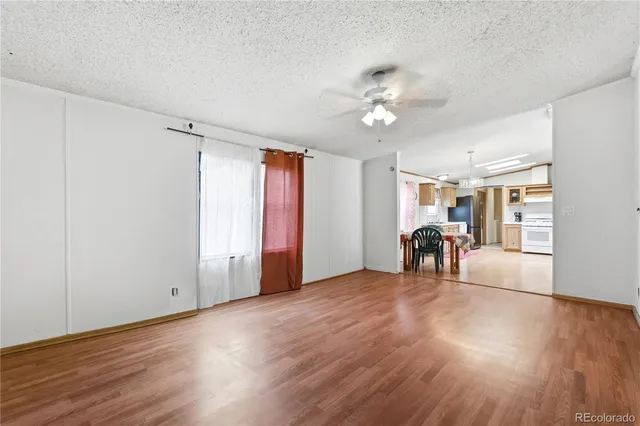 a view of a livingroom with hardwood floor and a ceiling fan