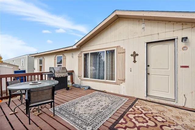 a view of a patio with a table and chairs