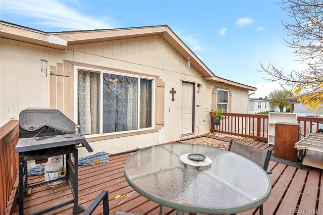 a balcony with table and chairs