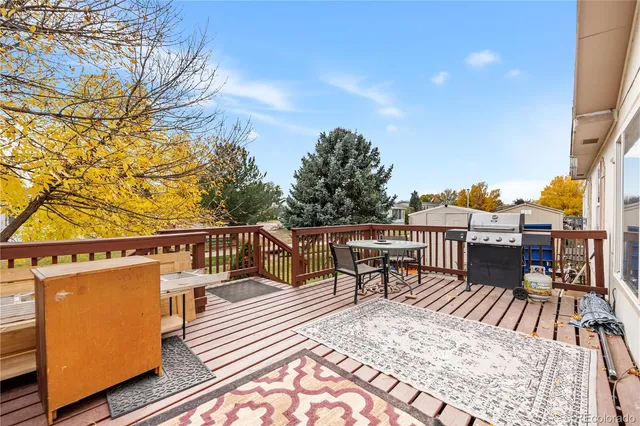 a view of a balcony with two chairs and a table
